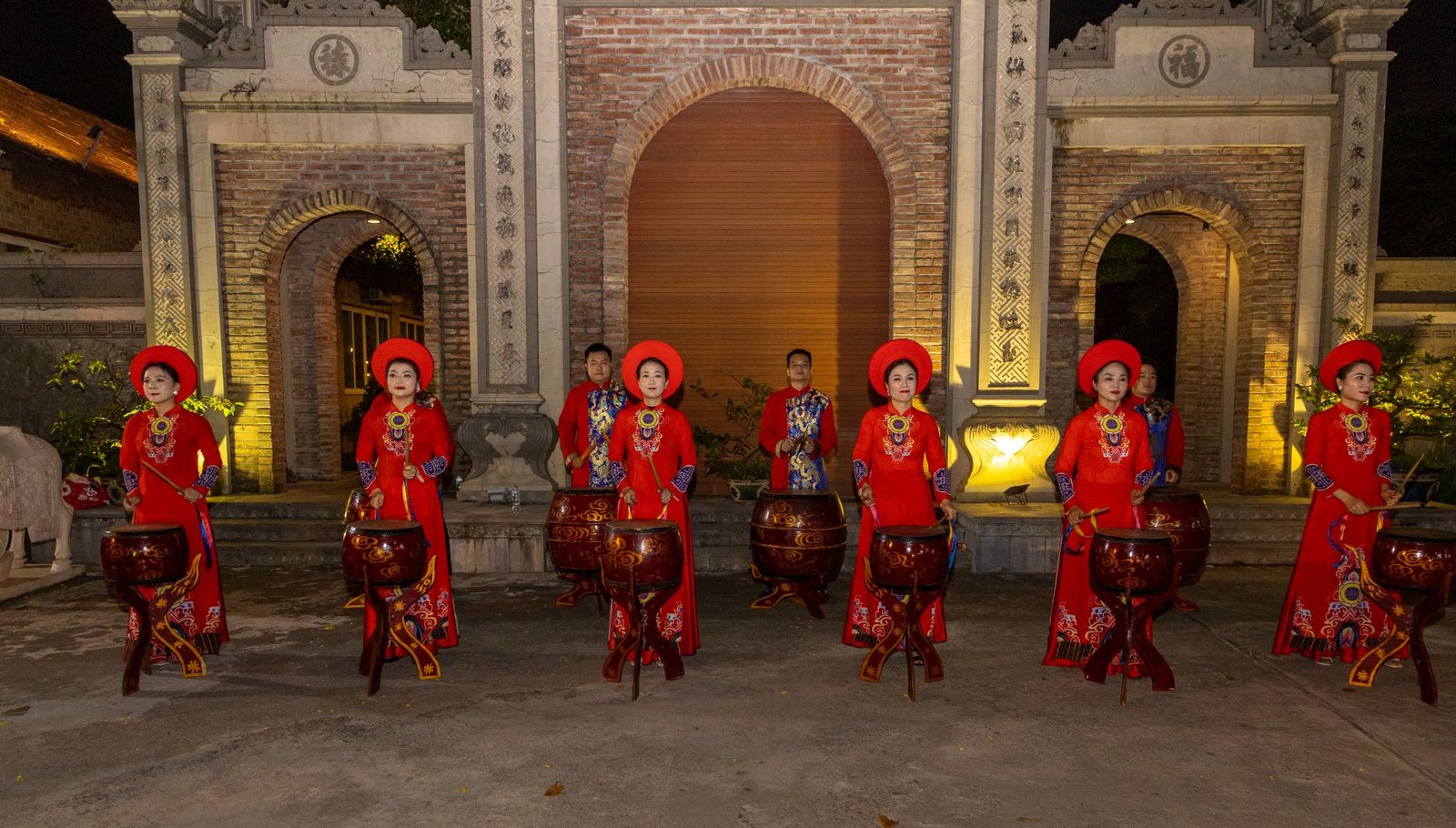 Traditional Vietnamese drummers performing at an evening event