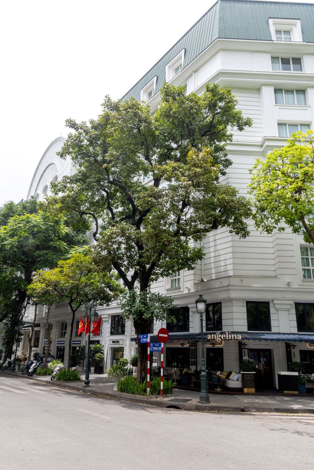 Hotel exterior on a tree-lined street in Hanoi, Vietnam